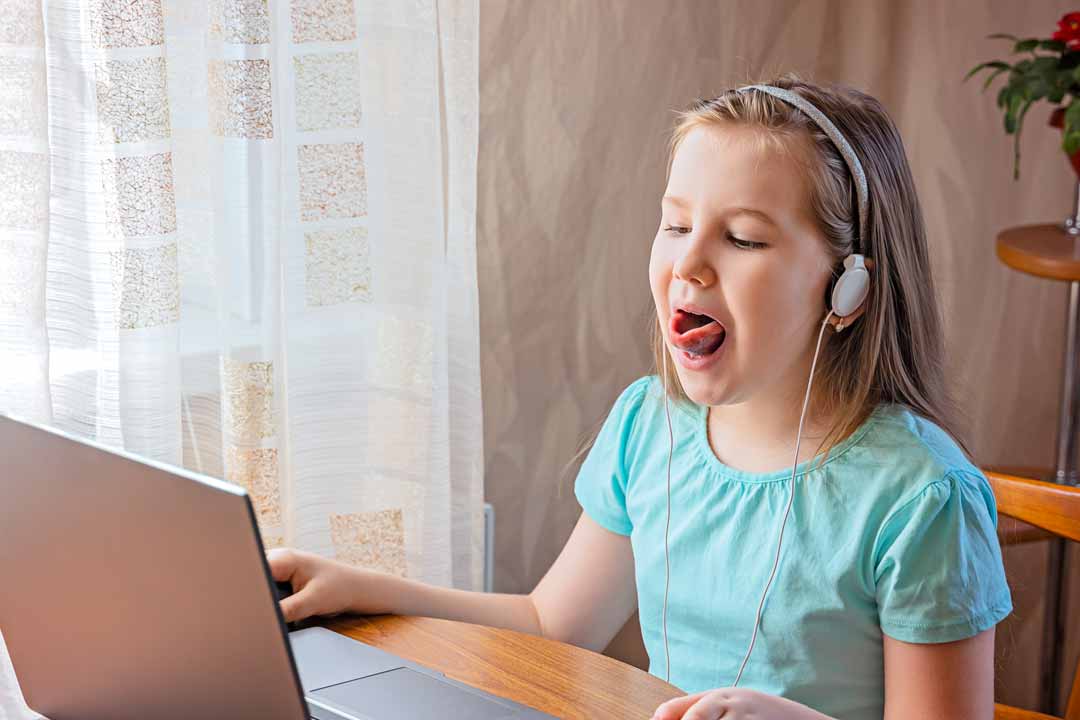 Young girl doing virtual speech therapy